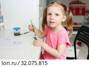 Cute lovely little girl painting with foam brush at home. Стоковое фото, фотограф ivolodina / Фотобанк Лори