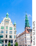 Stork Fountain in Amagertorv Square with old buildings and St Nikolaj Church tower Amager Torv, Copenhagen Denmark. Редакционное фото, фотограф Николай Коржов / Фотобанк Лори
