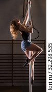 Young woman in denim shorts practicing pole dancing. Стоковое фото, фотограф Яков Филимонов / Фотобанк Лори