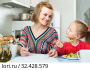 woman and her daughter working with papers from home. Стоковое фото, фотограф Яков Филимонов / Фотобанк Лори
