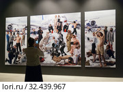 Женщина фотографирует фотоколлаж «Allegoria Sacra. Snow Elegy» Выставочный проект «AES+F. Предсказания и откровения». Центральный выставочный зал "Манеж". Санкт-Петербург (2019 год). Редакционное фото, фотограф Румянцева Наталия / Фотобанк Лори