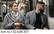 Positive bearded guy enjoying friendly conversation with young woman while traveling on subway train. Стоковое видео, видеограф Яков Филимонов / Фотобанк Лори