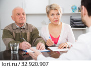 Woman and eldery man with bank employee. Стоковое фото, фотограф Яков Филимонов / Фотобанк Лори