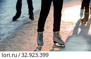 A woman on ice rink skating on the rink outdoors. Стоковое видео, видеограф Константин Шишкин / Фотобанк Лори