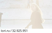 A young blonde woman skating on the ice rink in bright sunlight. Стоковое видео, видеограф Константин Шишкин / Фотобанк Лори