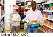 Portrait of male and female customers choosing stationery at store. Стоковое фото, фотограф Яков Филимонов / Фотобанк Лори