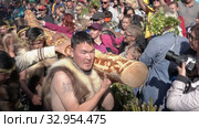 Itelmens national ritual festival of thanksgiving nature Alhalalalay. People in traditional clothing aboriginal conducts ritual - carry idol and offer food. Kamchatka Peninsula (2019 год). Редакционное видео, видеограф А. А. Пирагис / Фотобанк Лори
