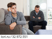 Silent resentment between father and teenager son. Стоковое фото, фотограф Яков Филимонов / Фотобанк Лори