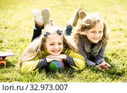 children enjoy lying on the grass. Стоковое фото, фотограф Татьяна Яцевич / Фотобанк Лори