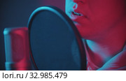 A man rapping through the pop-filter in the microphone. Стоковое видео, видеограф Константин Шишкин / Фотобанк Лори