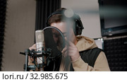 A man rapper recording his track in the studio - getting shy and stop recording. Стоковое видео, видеограф Константин Шишкин / Фотобанк Лори