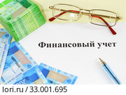 Очки, деньги, ручка и надпись "Финансовый учет" Стоковое фото, фотограф Наталья Гармашева / Фотобанк Лори