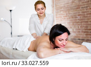 Professional masseuse is doing massage of back and loin to adult woman. Стоковое фото, фотограф Яков Филимонов / Фотобанк Лори