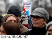 Женщина держит в руке Конституцию Российской Федерации во время шествия по Тверскому бульвару города Москвы, протестуя против внесения изменений в Конституцию, предложенных Владимиром Путиным, 19 января 2020. Редакционное фото, фотограф Николай Винокуров / Фотобанк Лори