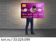 Businessman in credit card burden concept in pillory. Стоковое фото, фотограф Elnur / Фотобанк Лори