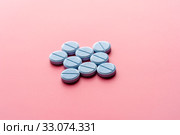 Close-up of bkue pills lie on a pink surface. Стоковое фото, фотограф Pavel Biryukov / Фотобанк Лори