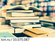 stack of books lying on table in bookstore. Стоковое фото, фотограф Татьяна Яцевич / Фотобанк Лори