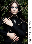 Emotions. Pretty woman posing in cage outdoors. Стоковое фото, фотограф Iryna Hramavataya / PantherMedia / Фотобанк Лори