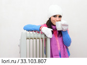Girl sitting on the floor next to a radiator and drinking tea. Стоковое фото, фотограф Арестов Андрей Павлович / Фотобанк Лори
