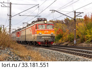 Russia, Samara, September 2019: Passenger train with wagons VL10 moves by rail through the beautiful Autumn Forest. Редакционное фото, фотограф Акиньшин Владимир / Фотобанк Лори