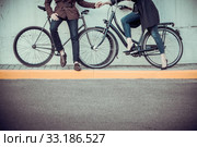 Young couple with a bicycle opposite city. Стоковое фото, фотограф Volodymyr Melnyk / PantherMedia / Фотобанк Лори