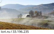 Small cottage in the mountains in the morning fog. Стоковое фото, фотограф Erika Eros / Smarterpix / Фотобанк Лори