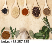 Various spices on kitchen spoons on grunge table. Стоковое фото, фотограф Erika Eros / Smarterpix / Фотобанк Лори