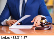 Handsome judge with gavel sitting in courtroom. Стоковое фото, фотограф Elnur / Фотобанк Лори