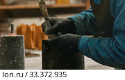 Concrete industry - a man working with a chisel to clean up the form. Стоковое видео, видеограф Константин Шишкин / Фотобанк Лори