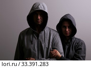 Man and woman in hoods stand by, low key. Стоковое фото, фотограф Владимир Арсентьев / Фотобанк Лори