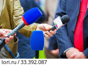 the hands of journalists hold microphones for an interview at a city festival in the park. Стоковое фото, фотограф Акиньшин Владимир / Фотобанк Лори