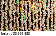 In foreground 3D glasses, which then male hand removes from frame. Defocused dynamic background of garlands from popcorn and golden sparkling tinsel. Garlands of popcorn for sports and movie news. Стоковое видео, видеограф Dmitry Domashenko / Фотобанк Лори