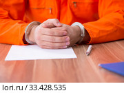 Young man writing letter in provisional detention. Стоковое фото, фотограф Elnur / Фотобанк Лори