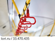Interior elements of public transport - city bus grab handles - on a blurred background. Стоковое фото, фотограф Евгений Харитонов / Фотобанк Лори