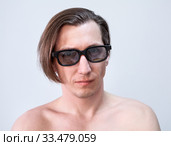 Adult Caucasian man wearing tinted glasses, naked torso, a long hair, looking at camera. Стоковое фото, фотограф Кекяляйнен Андрей / Фотобанк Лори