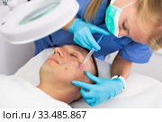 Female doctor is doing injection to patient in skin of face. Стоковое фото, фотограф Яков Филимонов / Фотобанк Лори