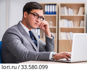 Young businessman sitting at the desk. Стоковое фото, фотограф Elnur / Фотобанк Лори