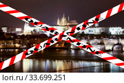 Coronavirus in Prague, Czech Republic. Vltava river, Charles Bridge and St. Vitus Cathedral. Quarantine sign on a blurred background. Concept of COVID pandemic and travel in Europe. (2019 год). Стоковое фото, фотограф Владимир Журавлев / Фотобанк Лори