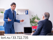 Yound and old employees in business presentation concept. Стоковое фото, фотограф Elnur / Фотобанк Лори