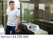Passenger near baffle gate in underground. Стоковое фото, фотограф Яков Филимонов / Фотобанк Лори
