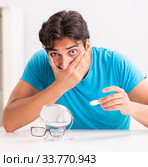 Man trying contact lenses at home. Стоковое фото, фотограф Elnur / Фотобанк Лори