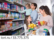 Family purchasing yoghurts in supermarket. Стоковое фото, фотограф Яков Филимонов / Фотобанк Лори