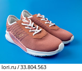 Moscow, Russia - May 15. 2020 Brown textile Ascot sneakers on a blue background. Редакционное фото, фотограф Володина Ольга / Фотобанк Лори