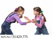 two girls quarrel and fight with each other on a white background. Стоковое фото, фотограф Иванов Алексей / Фотобанк Лори