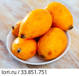 Whole and half fresh yellow loquat on wooden table. Стоковое фото, фотограф Яков Филимонов / Фотобанк Лори
