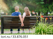 Relaxed young family on the bench in the park. Стоковое фото, фотограф Дмитрий Травников / Фотобанк Лори