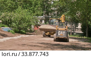 Two skid steer loaders moving sand soil at construction area outdoors. Редакционное видео, видеограф Сергей Старуш / Фотобанк Лори