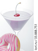 A glass of martini and a pink and white striped donut close-up. photo for the screensaver. In a glass of milkshake milkshake. One cherry on top. Стоковое фото, фотограф Evgeny Miller / Фотобанк Лори