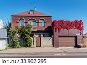 Barnaul, Russia - September, 22, 2019: Two-story cottage with a balcony and a garage on Sibirsky Avenue. Редакционное фото, фотограф Вадим Орлов / Фотобанк Лори