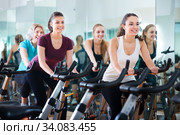 Females training on exercise bikes. Стоковое фото, фотограф Яков Филимонов / Фотобанк Лори